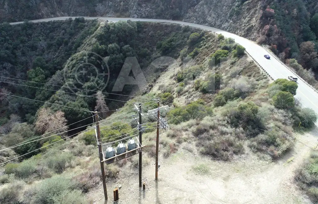 Oblique aerial drone photo of utility infrastructure above a Southern California canyon road